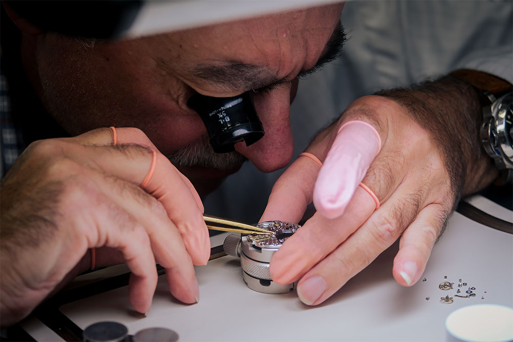 Watch repair planning board with timepieces, precision tools and service notes